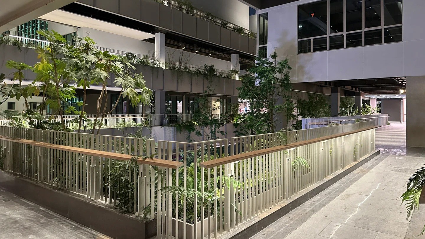 Balcony railings and handrails around a planted courtyard