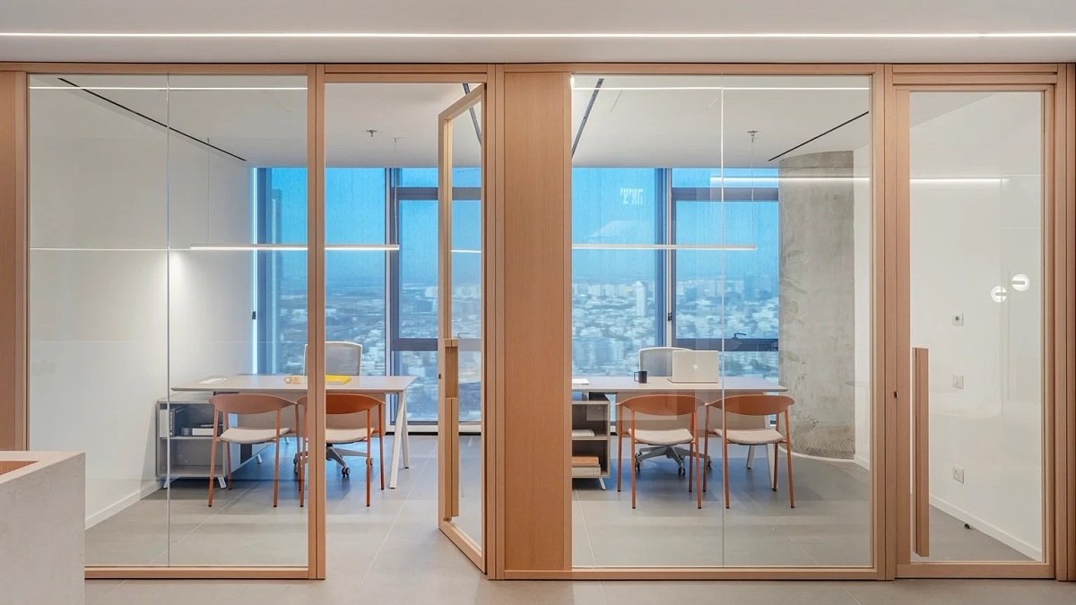Wood-finish framed glass partition separating interior rooms