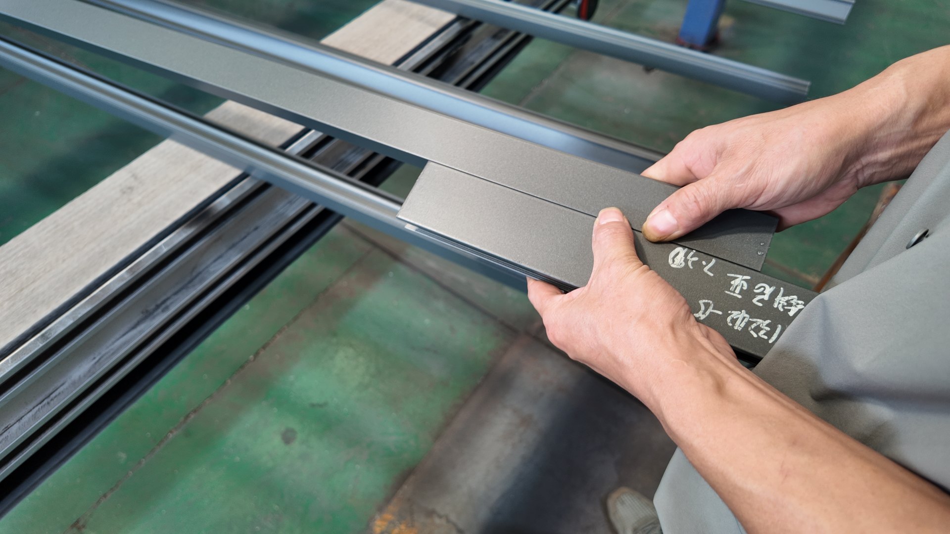 A worker comparing surface finish samples against coated profiles