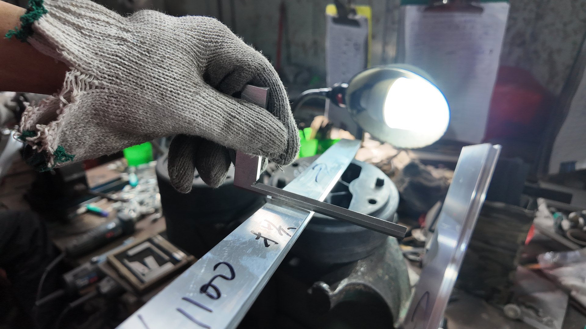Manual checking of an aluminum profile at the workbench