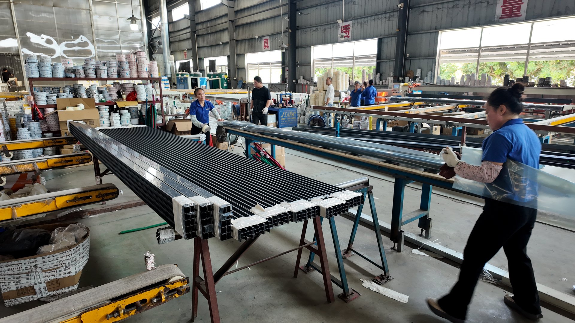 Factory team handling profiles at the packing work area
