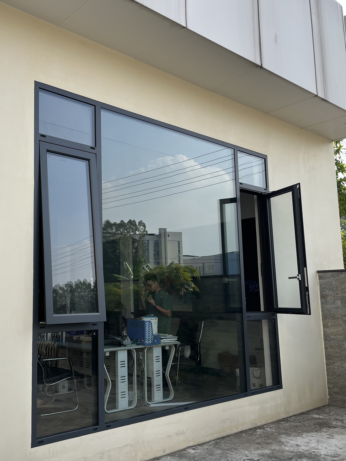 Dark-framed window with an open casement at the Guantian showroom